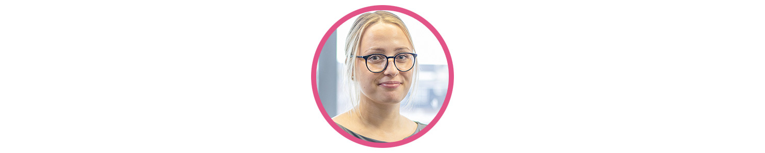Photo of Athena Jones, a young white woman with blonde hair, blue eyes, and round flared glasses. She is smiling at the camera.