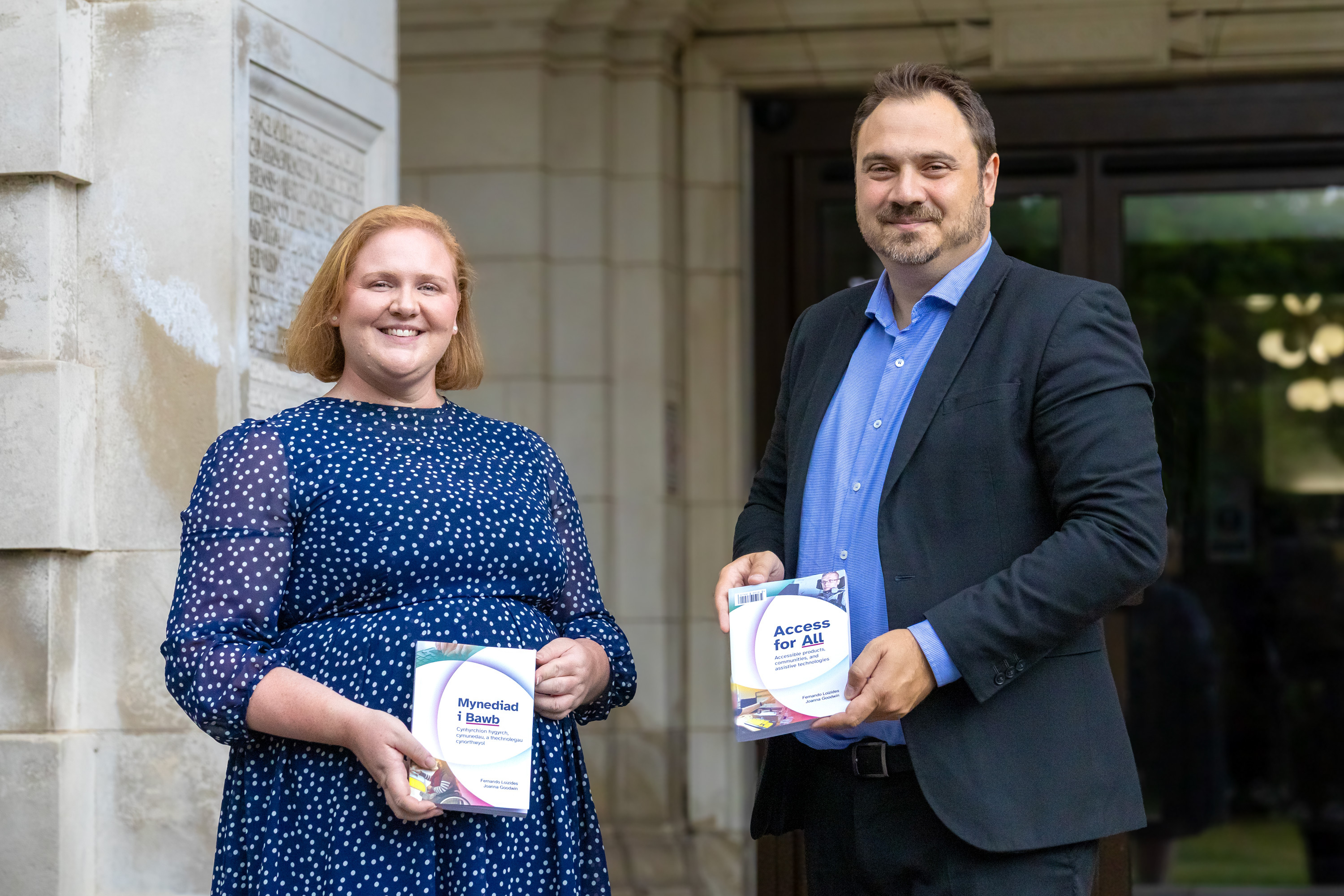 Joanna Goodwin and Fernando Loizides holding copies of the Access for All books.
