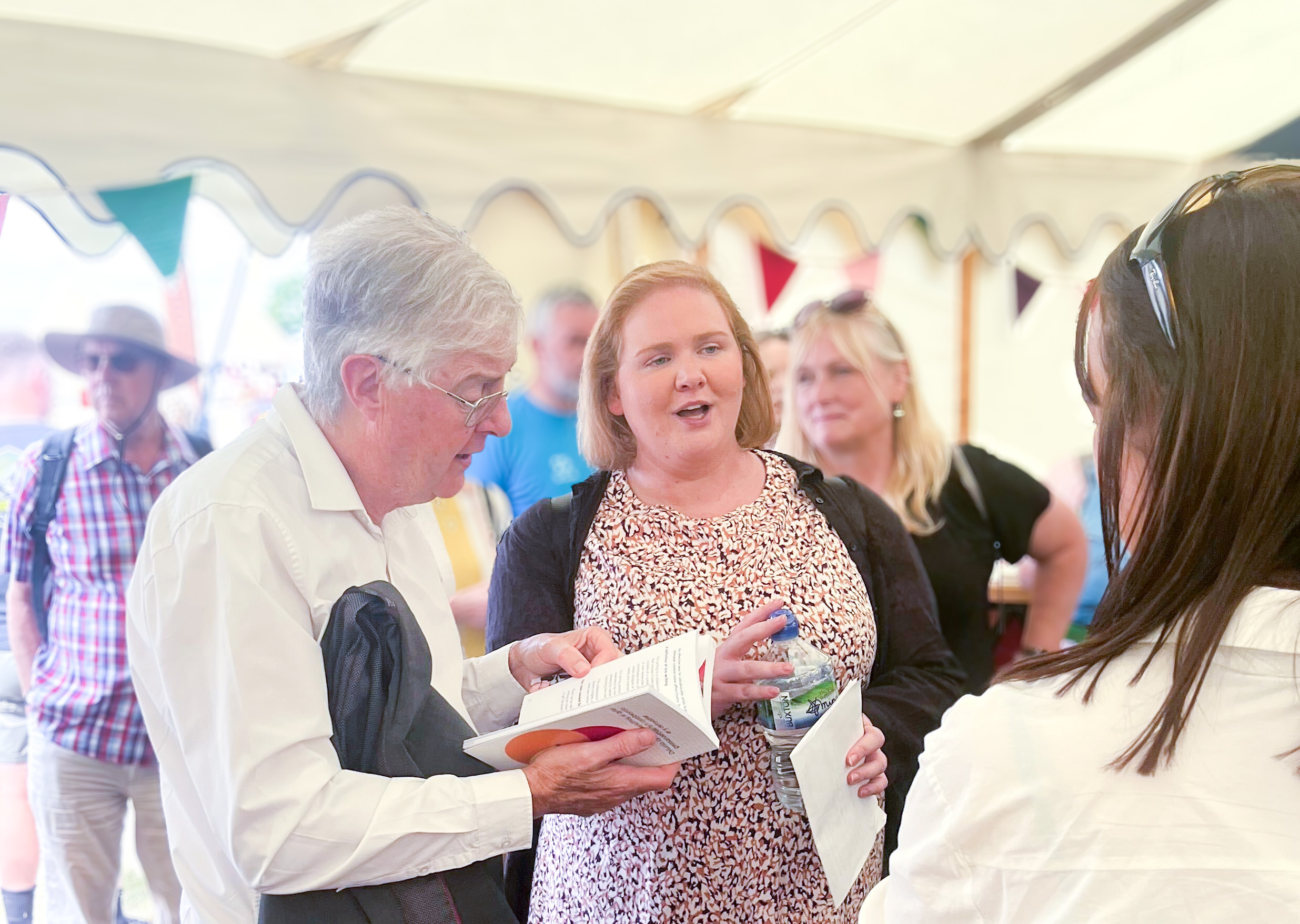 Joanna Goodwin, Head of Delivery and User Centred Design at CDPS talking to Mark Drakeford, former First Minister for Wales in the Welsh Government tent at the National Eisteddfod.
